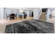 Open basement with kitchen, stairs, eating area and large area rug with a modern design at 3058 Mcintosh Dr, Bargersville, IN 46106