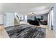 Expansive basement living area with comfortable leather seating, stairs, and a large rug at 3058 Mcintosh Dr, Bargersville, IN 46106