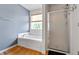 Well-lit bathroom with a soaking tub, glass-enclosed shower, and hardwood floors at 3058 Mcintosh Dr, Bargersville, IN 46106