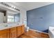Bathroom features a dual vanity, toilet, and a tub set beneath a large window at 3058 Mcintosh Dr, Bargersville, IN 46106