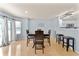 Bright dining room with wooden table set, hardwood floors, and sliding doors to the backyard at 3058 Mcintosh Dr, Bargersville, IN 46106