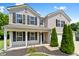 Inviting two-story home featuring a covered porch with elegant columns and a neatly landscaped yard at 3058 Mcintosh Dr, Bargersville, IN 46106