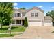 Charming two-story home with a well-manicured lawn, two-car garage, and a basketball hoop in the driveway at 3058 Mcintosh Dr, Bargersville, IN 46106