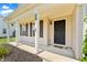 Close-up of the front porch featuring a black front door and support columns with black shutters at 3058 Mcintosh Dr, Bargersville, IN 46106