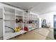 The garage boasts built-in white shelves, providing organized storage options for tools and supplies at 3058 Mcintosh Dr, Bargersville, IN 46106