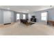 Bright living room with neutral walls, carpeting, and a TV on an elegant wood stand at 3058 Mcintosh Dr, Bargersville, IN 46106