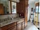 Bathroom featuring a double vanity with marble top, framed mirror and custom oak cabinets at 3422 Sycamore Dr, Columbus, IN 47203