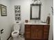 Bathroom featuring a vanity with marble top, framed mirror and decorative wall art at 3422 Sycamore Dr, Columbus, IN 47203