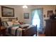 Comfortable bedroom with a ceiling fan, dresser, and natural light from the window at 3422 Sycamore Dr, Columbus, IN 47203