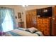 Comfortable bedroom with a ceiling fan, dresser, and natural light from the window at 3422 Sycamore Dr, Columbus, IN 47203