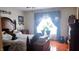 Cozy bedroom with hardwood floors, a queen-sized bed, and natural light from a large window at 3422 Sycamore Dr, Columbus, IN 47203