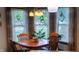 Bright dining room with a wooden table, chairs, and windows providing natural light at 3422 Sycamore Dr, Columbus, IN 47203