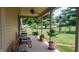 Inviting covered front porch with beautiful landscaping, seating, and a ceiling fan for added comfort at 3422 Sycamore Dr, Columbus, IN 47203