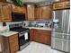 Spacious kitchen featuring a stainless steel refrigerator, stove and gas range, with custom wood cabinets at 3422 Sycamore Dr, Columbus, IN 47203