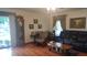 Cozy living room showcasing hardwood floors, a sofa, and a classic grandfather clock at 3422 Sycamore Dr, Columbus, IN 47203