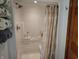 White shower with detachable shower head and curtain at 3422 Sycamore Dr, Columbus, IN 47203