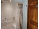White shower with detachable shower head and curtain at 3422 Sycamore Dr, Columbus, IN 47203