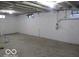 Unfinished basement with painted block walls ready for storage or recreation at 3455 Brouse Ave, Indianapolis, IN 46218