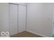 Bedroom with wood-look floors featuring sliding closet doors for ample storage at 3455 Brouse Ave, Indianapolis, IN 46218