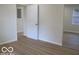Bedroom featuring a mirror sliding door closet and hardwood floors at 3455 Brouse Ave, Indianapolis, IN 46218