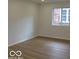 Bedroom with wood-look floors and a window for natural light at 3455 Brouse Ave, Indianapolis, IN 46218