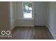 Inviting entryway features wood-look floors, white trim and a window for natural light at 3455 Brouse Ave, Indianapolis, IN 46218