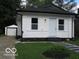 Newly renovated bungalow with white siding, black trim, updated walkway and detached garage at 3455 Brouse Ave, Indianapolis, IN 46218