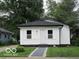 Charming renovated bungalow with white siding, contrasting trim and a well-manicured lawn at 3455 Brouse Ave, Indianapolis, IN 46218