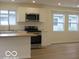 Updated kitchen features stainless appliances, stone countertops, and a center island at 3455 Brouse Ave, Indianapolis, IN 46218