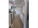 Bright, updated kitchen featuring wood-look flooring, stainless appliances and island at 3455 Brouse Ave, Indianapolis, IN 46218