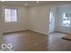 Bright, airy living room showcasing wood-look floors, neutral walls, and ample natural light at 3455 Brouse Ave, Indianapolis, IN 46218