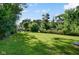 Large, lush backyard surrounded by mature trees, perfect for outdoor activities and relaxation at 3508 Brouse Ave, Indianapolis, IN 46218