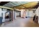 Unfinished basement providing ample storage space, exposed brick, and a staircase at 3508 Brouse Ave, Indianapolis, IN 46218