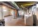 Unfinished basement with exposed ductwork, washer, and dryer, offering potential for customization at 3508 Brouse Ave, Indianapolis, IN 46218