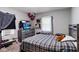 Comfortable bedroom with a plaid comforter, dresser, and natural light at 3508 Brouse Ave, Indianapolis, IN 46218