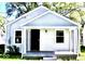 Charming bungalow with horizontal siding, a porch, and a black front door at 3508 Brouse Ave, Indianapolis, IN 46218