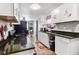 Well-lit kitchen features white cabinets, sleek countertops, and modern appliances at 3508 Brouse Ave, Indianapolis, IN 46218