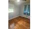 Bright bedroom with hardwood floors, large window, and neutral wall color at , Indianapolis, IN 46227