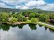 Scenic aerial view of the lake, surrounded by lush greenery, highlighting the natural beauty of the property's setting at 3813 N Ramsgate Rd, Martinsville, IN 46151