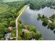 Stunning aerial view of a home nestled among lush greenery, with a serene lake and expansive landscape at 3813 N Ramsgate Rd, Martinsville, IN 46151