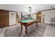 Finished basement featuring a pool table, living area, and staircase leading to the upper level at 3813 N Ramsgate Rd, Martinsville, IN 46151