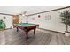 Basement boasting a pool table with updated vinyl flooring and neutral wall colors creating a game room at 3813 N Ramsgate Rd, Martinsville, IN 46151