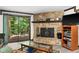 Cozy living room with a stone fireplace, a sliding glass door to the outside patio, and natural light at 3813 N Ramsgate Rd, Martinsville, IN 46151