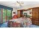 Cozy bedroom boasts a large bed, a ceiling fan, and a sliding glass door to the outside deck at 3813 N Ramsgate Rd, Martinsville, IN 46151