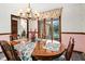 Elegant dining room with chandelier and views of the lake at 3813 N Ramsgate Rd, Martinsville, IN 46151