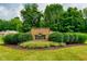 Community entrance sign with stone facade and lush landscaping, creating a welcoming and established atmosphere at 3813 N Ramsgate Rd, Martinsville, IN 46151