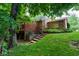 Exterior of home features a deck, stone accents and lush landscaping at 3813 N Ramsgate Rd, Martinsville, IN 46151