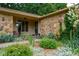 Inviting front porch with stone accents, lush landscaping, and a pathway leading to the front door at 3813 N Ramsgate Rd, Martinsville, IN 46151