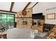 Cozy living room with stone fireplace and sliding glass door to outdoor deck at 3813 N Ramsgate Rd, Martinsville, IN 46151