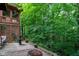 Outdoor patio with a fire pit, water fountain, and mature trees at 3813 N Ramsgate Rd, Martinsville, IN 46151